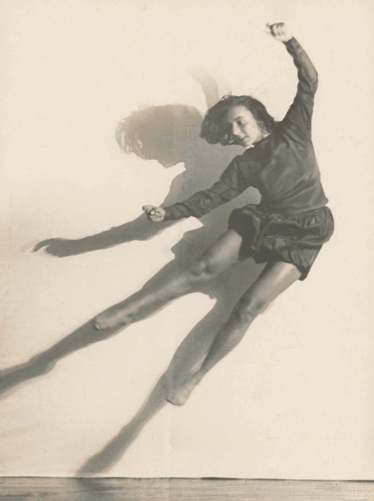 Photograph of dancer Gret Palucca jumping into the air, legs and arms stretched out wide. She is wearing a long-sleeved top and short, wavy pants. Credit: Charlotte Rudolph | The Dancer Gret Palucca, 1924 | The ALBERTINA Museum, Vienna – permanent loan from the Austrian Ludwig Foundation for Art and Science © Bildrecht, Vienna 2026