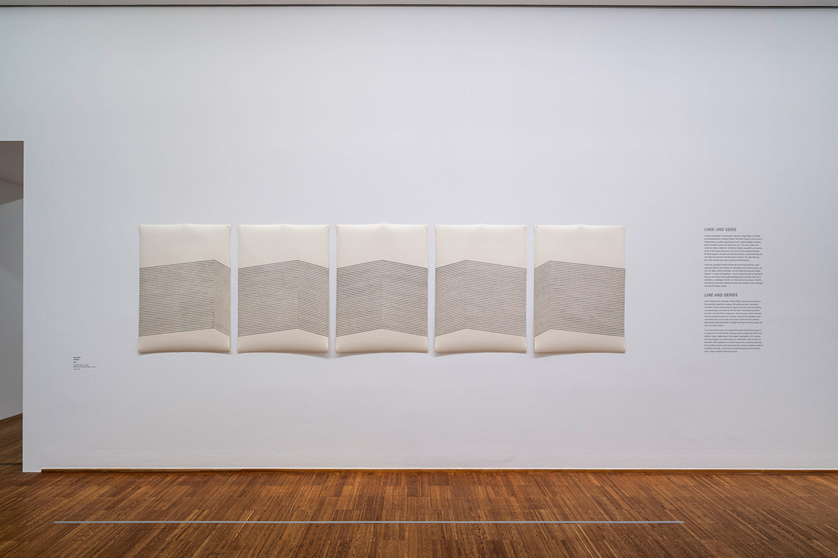 Exhibition view: five-part abstract graphite drawing by Helga Philipp on handmade paper, featuring a serial, geometric composition.